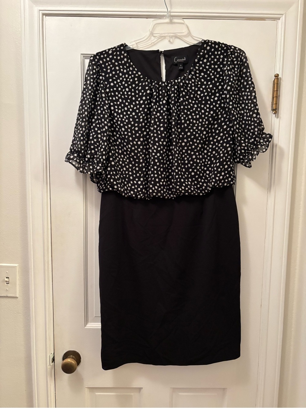 Connected Apparel Black and White Polka Dot Dress with Puff Sleeves.
Size 1